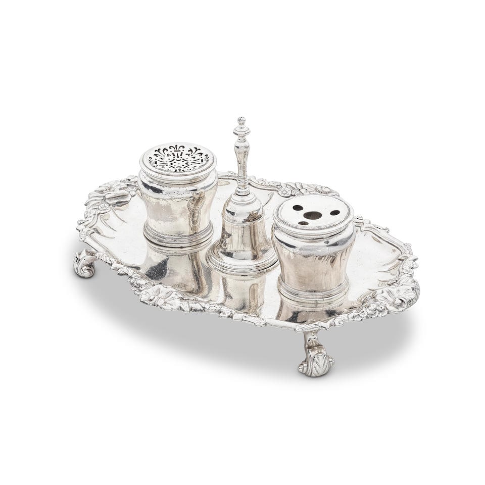 A George II silver inkstand Robert Brown, London 1743: A George II silver inkstand Robert Brown, London 1743 Shaped-oval form with acanthus and foliate scroll raised border, crested, on four scroll feet, the baluster form ink pot and pounce pot flanking