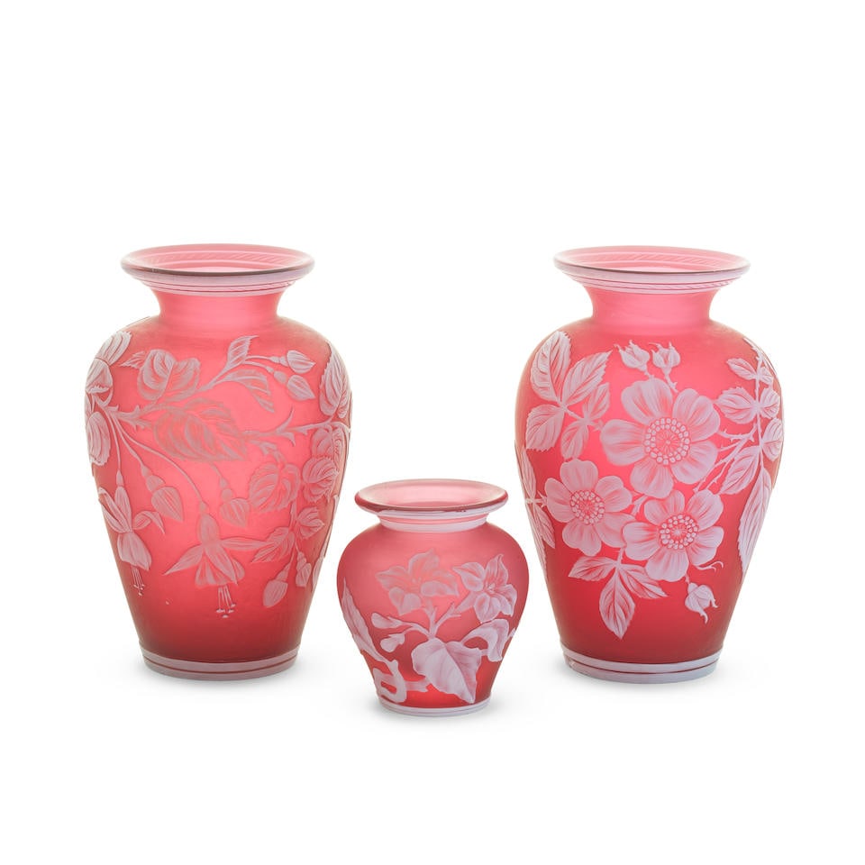 Three Stourbridge cameo glass vases attributed to Thomas Webb and Sons, circa 1885: Three Stourbridge cameo glass vases attributed to Thomas Webb and Sons, circa 1885 Each of baluster form in ruby-red glass overlaid in opaque white, comprising a pair, one finely carved with a spray o