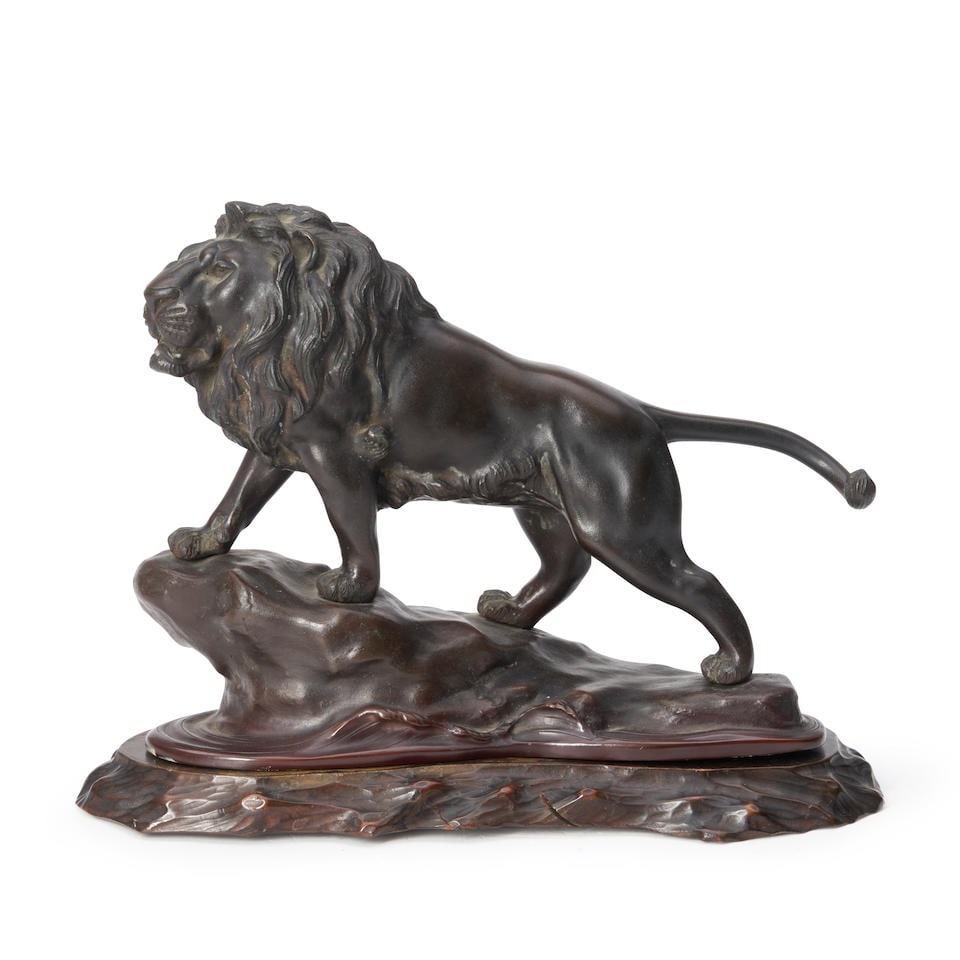 A BRONZE OKIMONO OF A STRIDING LION Japan, Meiji era (2 wood stand) (1 of 4)