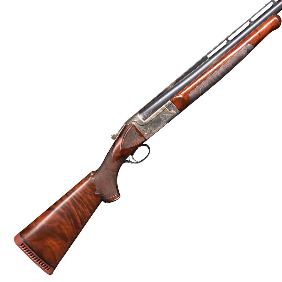 AN L.C. SMITH CROWN GRADE 12 GAUGE TRAP GUN, Curio or Relic firearm: AN L.C. SMITH CROWN GRADE 12 GAUGE TRAP GUN, c. 1921. Serial number S42850, blued ejector barrel with tall textured and ventilated rib, with scroll engraving at the breech and marked 'L.C. SMITH CROWN