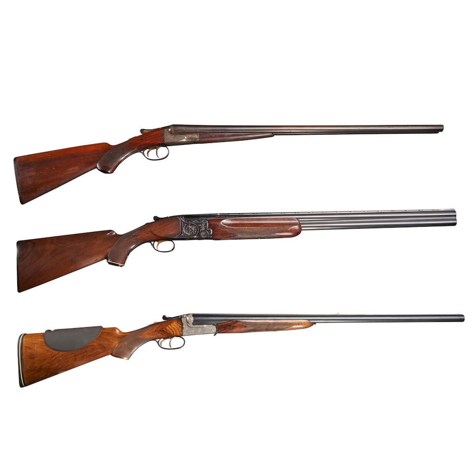 THREE SPORTING SHOTGUNS. Modern firearm: THREE SPORTING SHOTGUNS. A Charles Daly Over/Under shotgun, serial number 550960, 12 Gauge, blued barrels with textured and vented sight rib; foliate scroll engraved frame; walnut stock with checkered