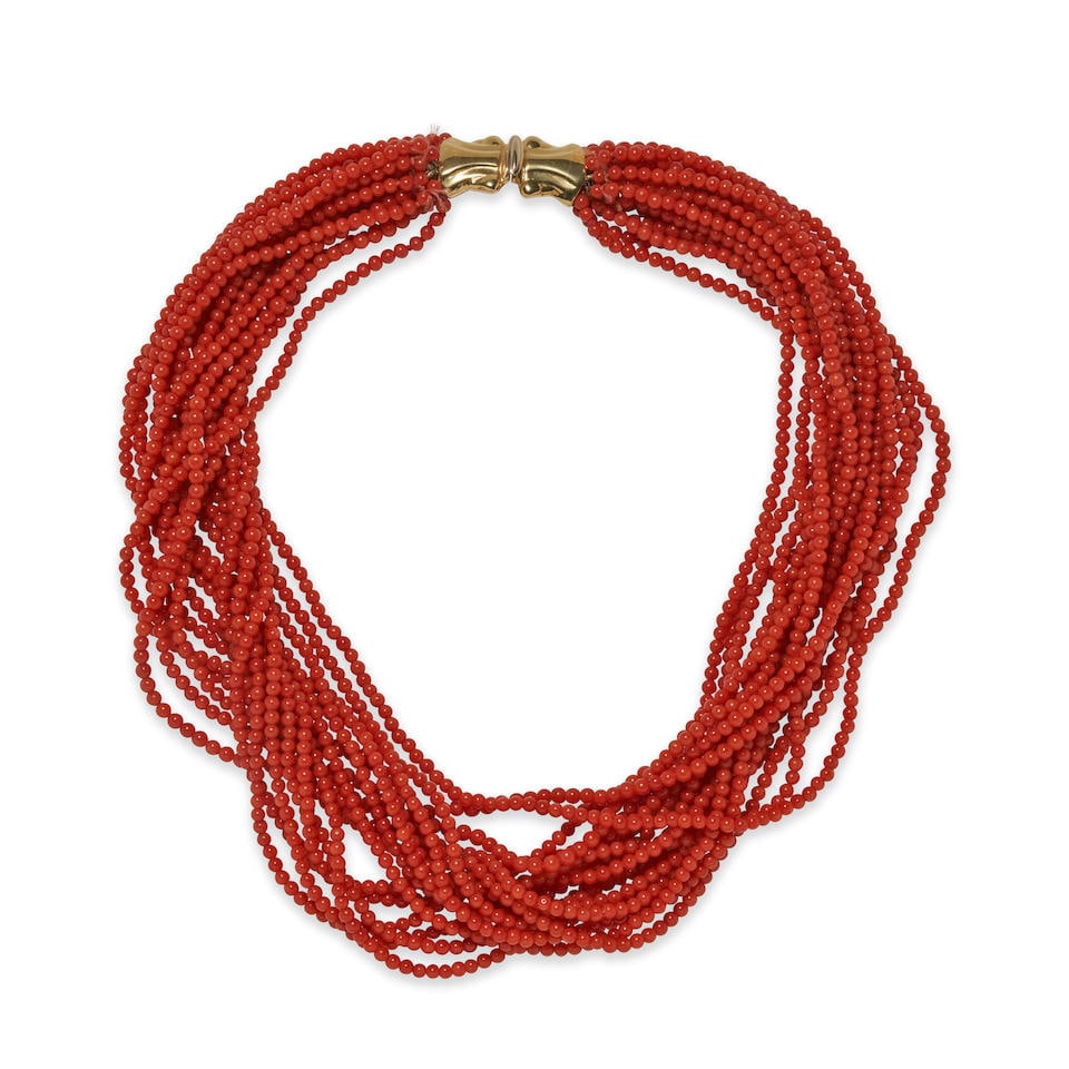 AN 18K GOLD AND CORAL TORSADE NECKLACE: AN 18K GOLD AND CORAL TORSADE NECKLACE The multistrand necklace composed coral beads, the beads ranging in size from approximately 2.75 to 3.20 mm, joined to a gold clasp, French guarantee stamps, len