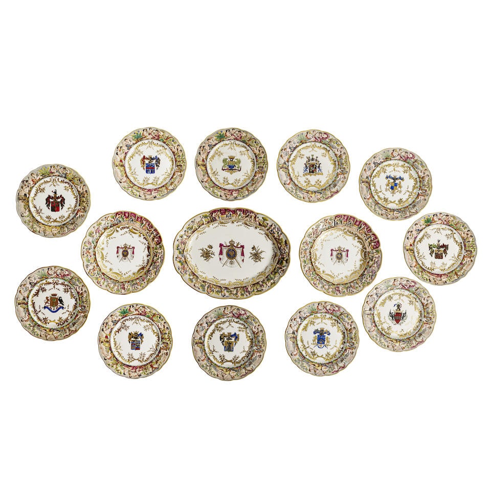 FOURTEEN CAPODIMONTE PORCELAIN ARMORIAL PLATES: FOURTEEN CAPODIMONTE PORCELAIN ARMORIAL PLATES Comprising thirteen dinner plates and one oval platter, all with various underglazed marks and inscriptions. length of platter 16 1/2in (42cm) Footnotes: