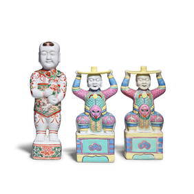 A PAIR OF FAMILLE ROSE 'FOREIGNER' CANDLE STICKS AND A FAMILLE VERTE FIGURE OF A STANDING BOY 19... (1 of 1)