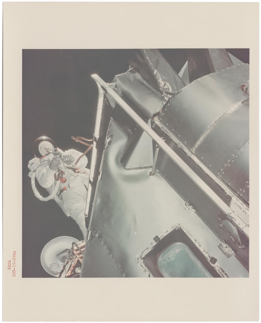 [Apollo 9] THE FIRST APOLLO EVA: Russell Schweickart spacewalking and capturing 16mm footage fro...: [Apollo 9] THE FIRST APOLLO EVA: Russell Schweickart spacewalking and capturing 16mm footage from LM Spider's porch, seen from CSM Gumdrop's hatch David Scott, March 3-13, 1969 Printed 1969. Vintage c
