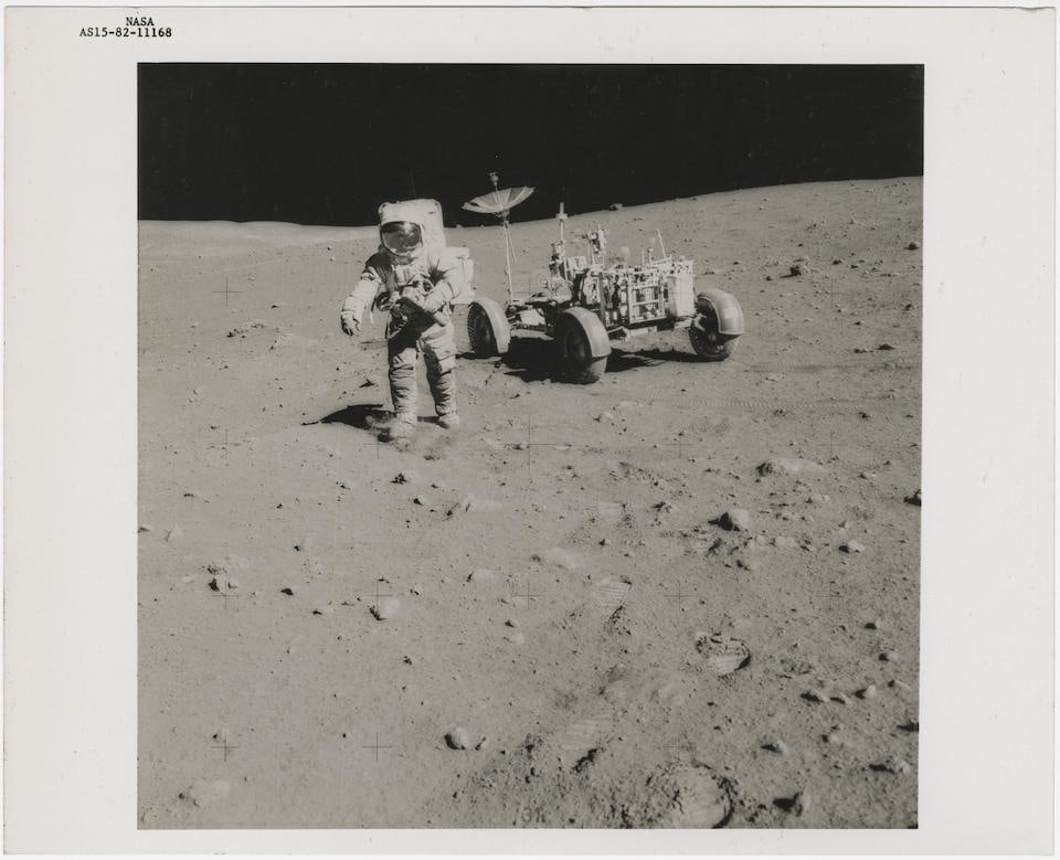 [Apollo 15] DAVID SCOTT WITH THE TELEPHOTO HASSELBLAD CAMERA BESIDE THE LUNAR ROVER AT STATION 1...: [Apollo 15] DAVID SCOTT WITH THE TELEPHOTO HASSELBLAD CAMERA BESIDE THE LUNAR ROVER AT STATION 10 James Irwin, July 26 - August 7, 1971, EVA 3 Printed 1971. Vintage gelatin silver print on fibre-based