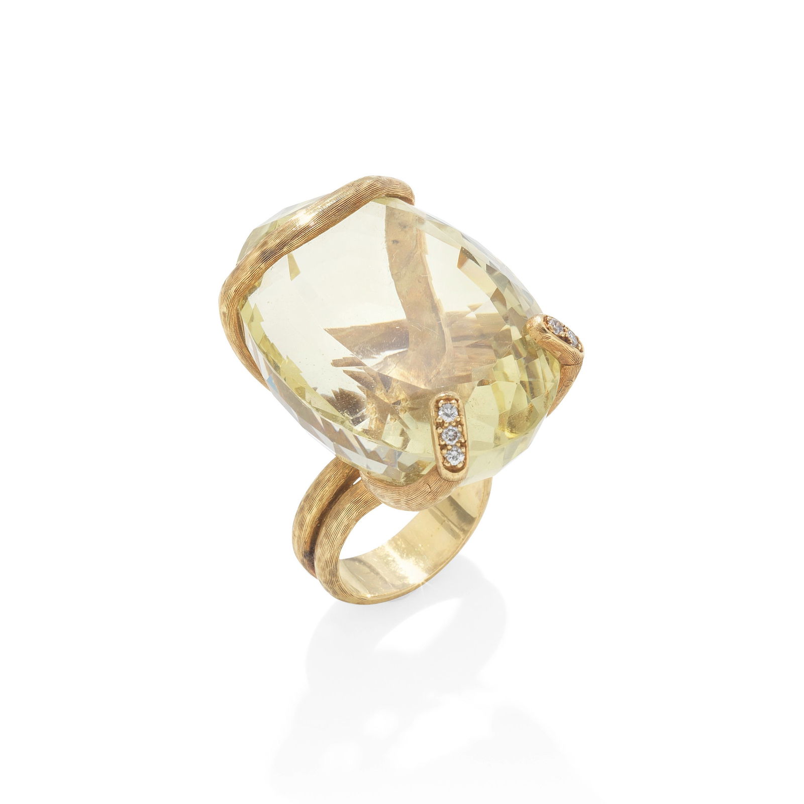GRIMA: CITRINE AND DIAMOND RING, CIRCA 1973: GRIMA: CITRINE AND DIAMOND RING, CIRCA 1973 The large oval-cut citrine, mounted in a sinuous textured ribbon, entwining to finish as the shank, accented with brilliant-cut diamonds, mounted in 18 cara
