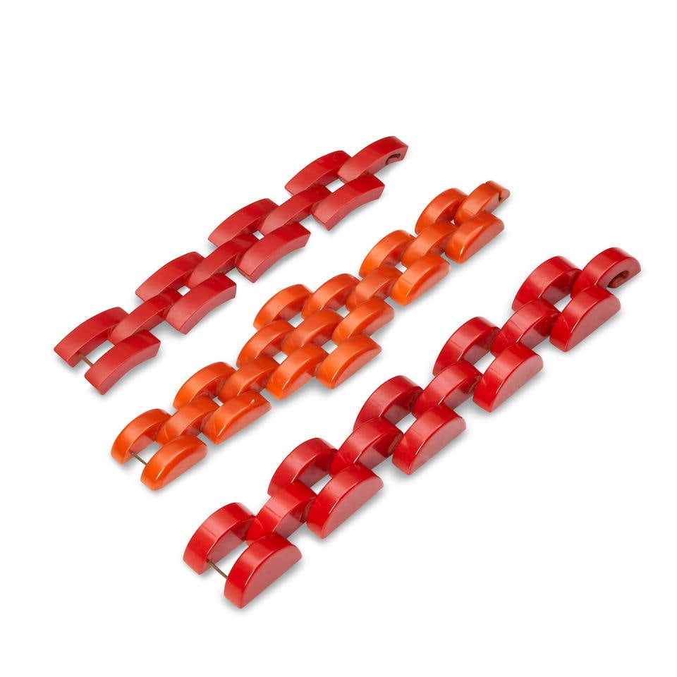 THREE BAKELITE LINK BRACELETS Each unmarked, orange, lg. 8 1/4, red semicircle links, lg. 9 1/4,...: THREE BAKELITE LINK BRACELETS Each unmarked, orange, lg. 8 1/4, red semicircle links, lg. 9 1/4, red band links, lg. 7 1/4 in. For further information on this lot please visit Bonhams.com For further
