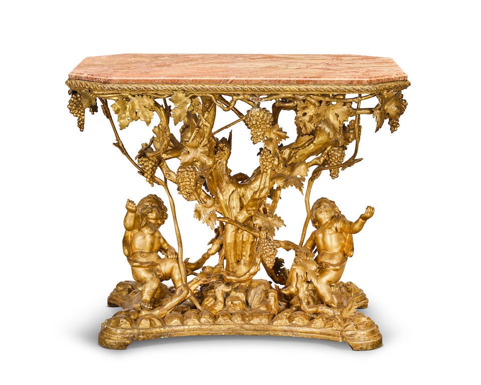 An Italian third quarter 19th century giltwood and gilt composition console table: An Italian third quarter 19th century giltwood and gilt composition console table Modelled naturalistically as a flourishing vine comprised of a central tree trunk entwined and interlocked with abunda