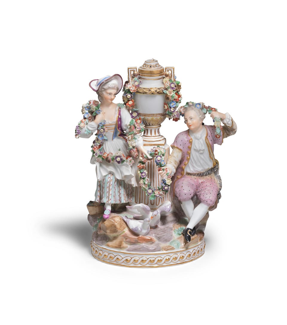 A later Marcolini Meissen group of young lovers and a maiden, circa 1814: A later Marcolini Meissen group of young lovers and a maiden, circa 1814 The group modelled on a neoclassical rockwork base, featuring a pair of lovers draped with floral garlands and both clutching a