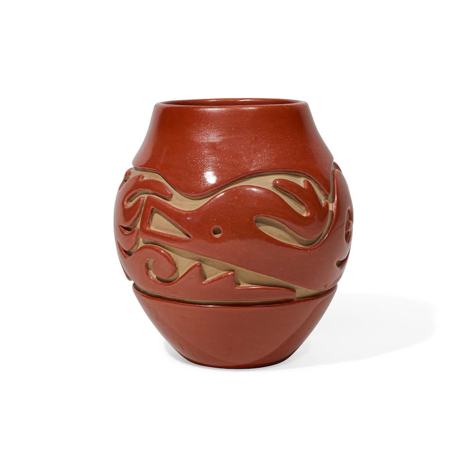 A Teresita Naranjo pottery jar: Teresita Naranjo Santa Clara Pueblo, (1919-1999), a redware pottery jar, carved about the body with organic abstract devices and a truncated Avanyu, signed on the base: Teresita / Naranjo / Apple Blos