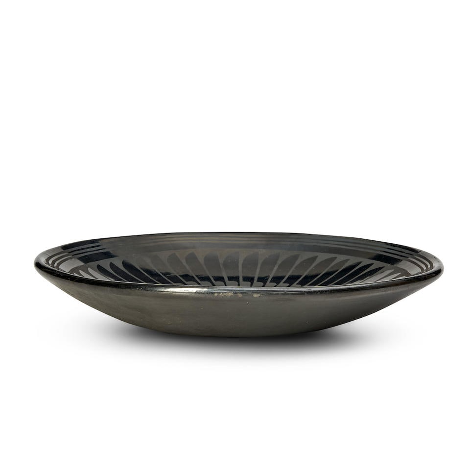 A Santana Martinez and Adam Martinez blackware plate Santana and Adam Martinez, San Ildefonso Pu...: A Santana Martinez and Adam Martinez blackware plate Santana and Adam Martinez, San Ildefonso Pueblo, (1909-2002) and (1903-2000) A blackware plate with a band of abstracted feathers below the three-b