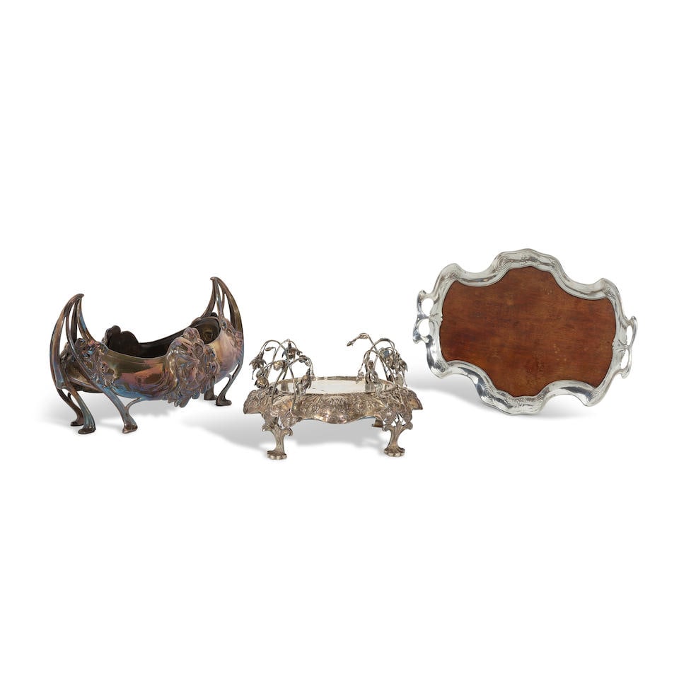 THREE ART NOUVEAU SILVER-PLATED HOLLOWARE by various makers, early 20th century: THREE ART NOUVEAU SILVER-PLATED HOLLOWARE by various makers, early 20th century Comprising a centerpiece plateau by Clemens Friedell, a Jugendstil jardinière centerpiece by Hugo Leven, and a wood
