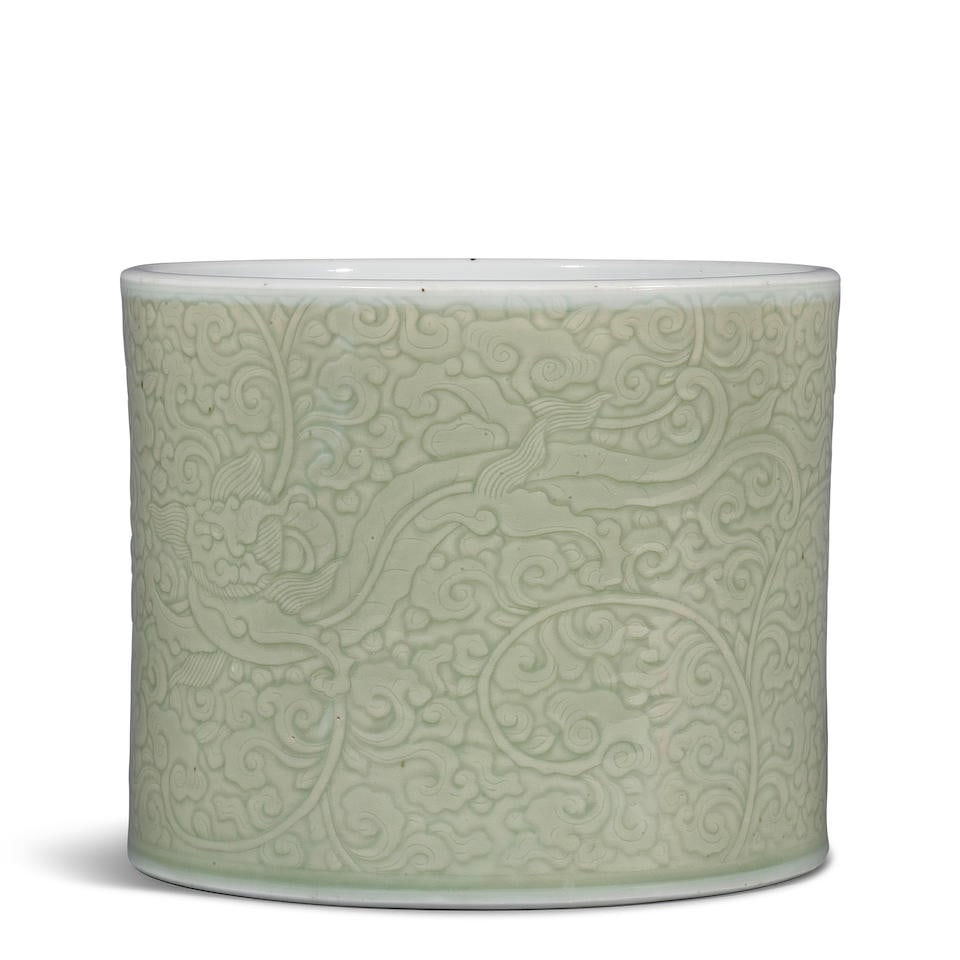 A CARVED CELADON-GLAZED 'CHILONG AND LINGZHI' BRUSHPOT Kangxi period