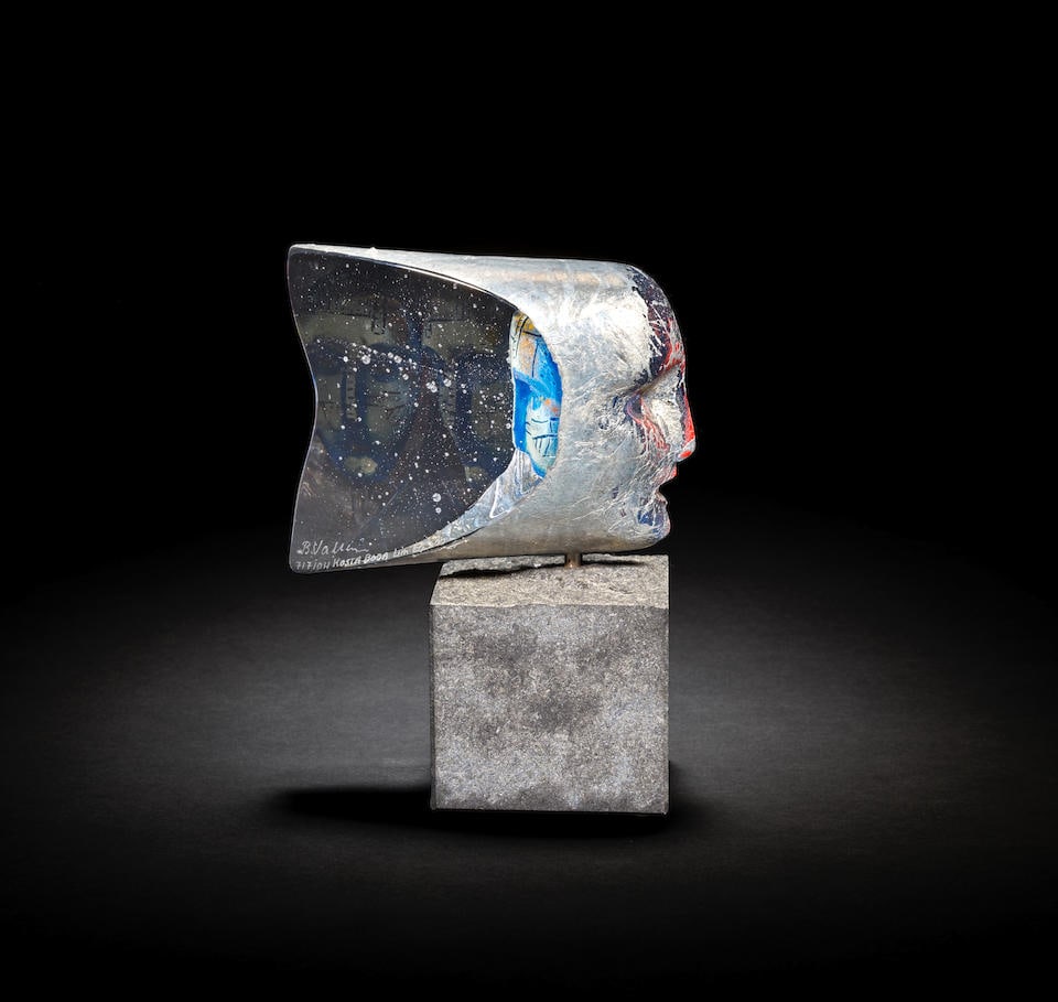 Bertil Vallien for Kosta Boda 'Janus', sculpture, 2001: Bertil Vallien for Kosta Boda 'Janus', sculpture, 2001 Sand-casted glass, pigment and foil inclusions, modelled as a two-sided head. Metal fixture and granite base. 17.5 x 13 x 7.5 cm From the edition