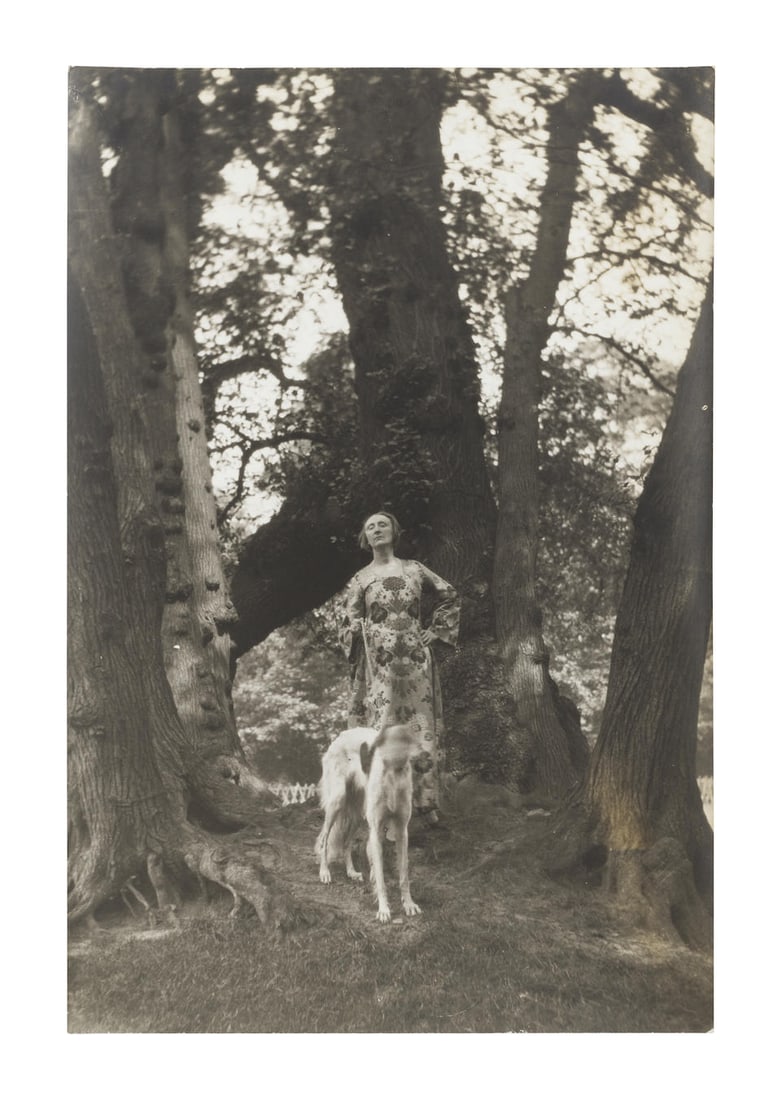 Cecil Beaton (British, 1904-1980); Edith Sitwell;: Cecil Beaton (British, 1904-1980) Edith Sitwell, circa 1930 Full-length, standing in a forest with a greyhound, circa 1930, bromide print, printed later, with photographer's ink-stamp credit to revers