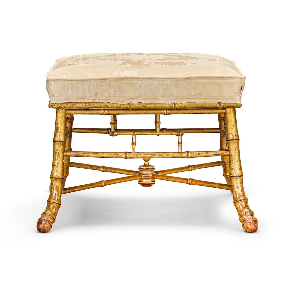 A small 'Brighton Pavillion' simulated bamboo stoolLate 19th century: A small 'Brighton Pavillion' simulated bamboo stool Late 19th century With stuff-over upholstered seat, gilded, 43cm wide x 42.5cm deep x 35cm high, (16 1/2in wide x 16 1/2in deep x 13 1/2in high) Thi