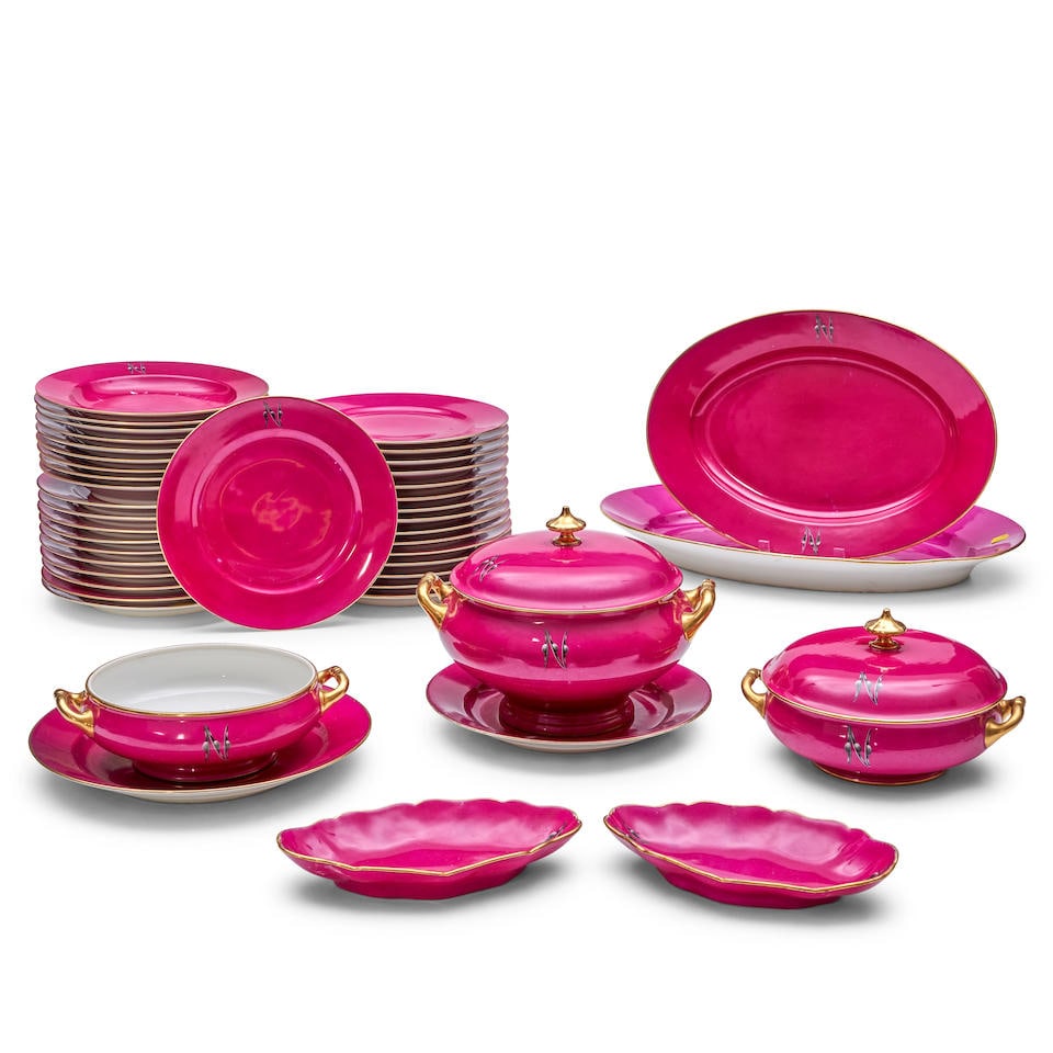 French Porcelain Partial Service, early 20th century,: French Porcelain Partial Service, early 20th century, from the Christopher Forbes Collection, each with wine red ground enhanced with an N in grisaille on the rim, including twenty-six dinner plates,