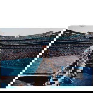 Terry O'Neill (1938-2019); Elton John Performing at Dodger Stadium, Los Angeles;: Terry O'Neill (1938-2019) Elton John Performing at Dodger Stadium, Los Angeles, 1975 Chromogenic print, printed later; signed and editioned '6/50' in white ink in the margin, framed. 12 x 18 in. (30.5