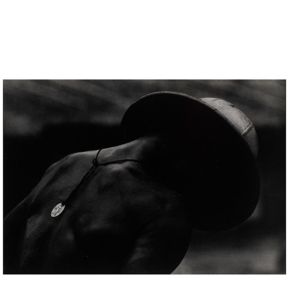 W. Eugene Smith (1918-1978); Leper Patient and Religious Medal at Dr. Albert Schweitzer's;: W. Eugene Smith (1918-1978) Leper Patient and Religious Medal at Dr. Albert Schweitzer's, 1954 Gelatin silver print, printed before 1978; the photographer's estate stamp on the reverse. 10 1/8 x 12 7/