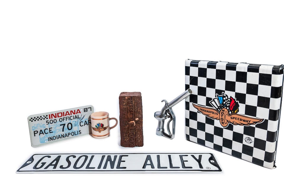 Indianapolis 500 collectibles and wall decor,: Indianapolis 500 collectibles and wall decor, plate autographed by Al Unser, original Brickyard brick, ceramic mug, gas nozzle, seat cushion and wall art. Lot to be sold without reserve. For further i