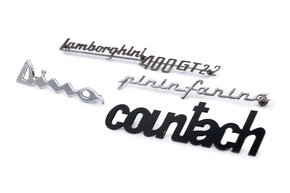 A mixed grouping of original car script badges, (1 of 8)