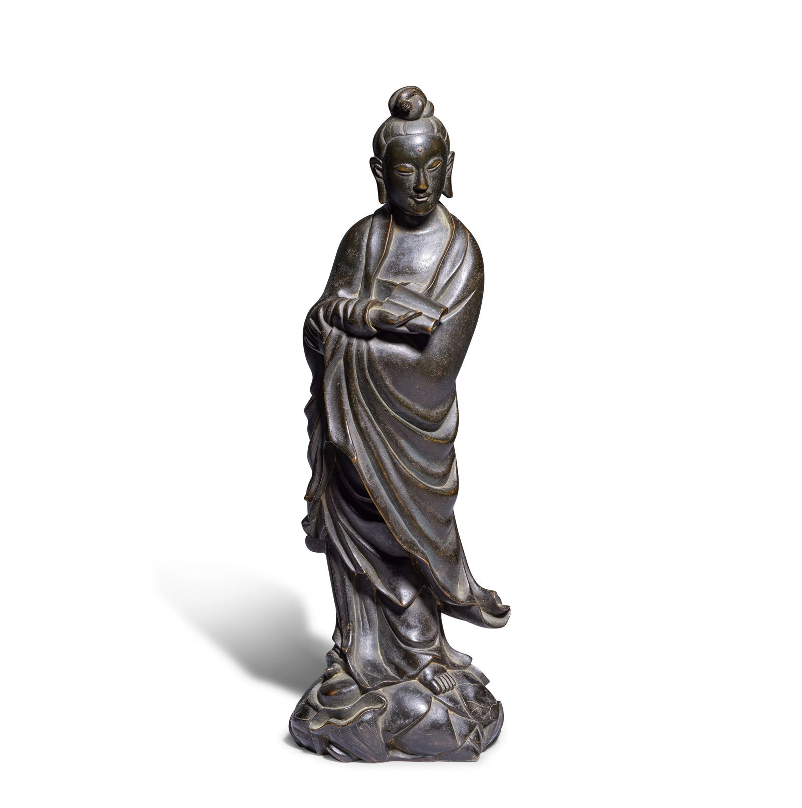 A LARGE BRONZE FIGURE OF GUANYIN Qing Dynasty: A LARGE BRONZE FIGURE OF GUANYIN Qing Dynasty The Guanyin standing on a lotus-leaf stand, dressed in a long flowing robe, holding a scroll in her right hand, her face serene and meditative with pendul