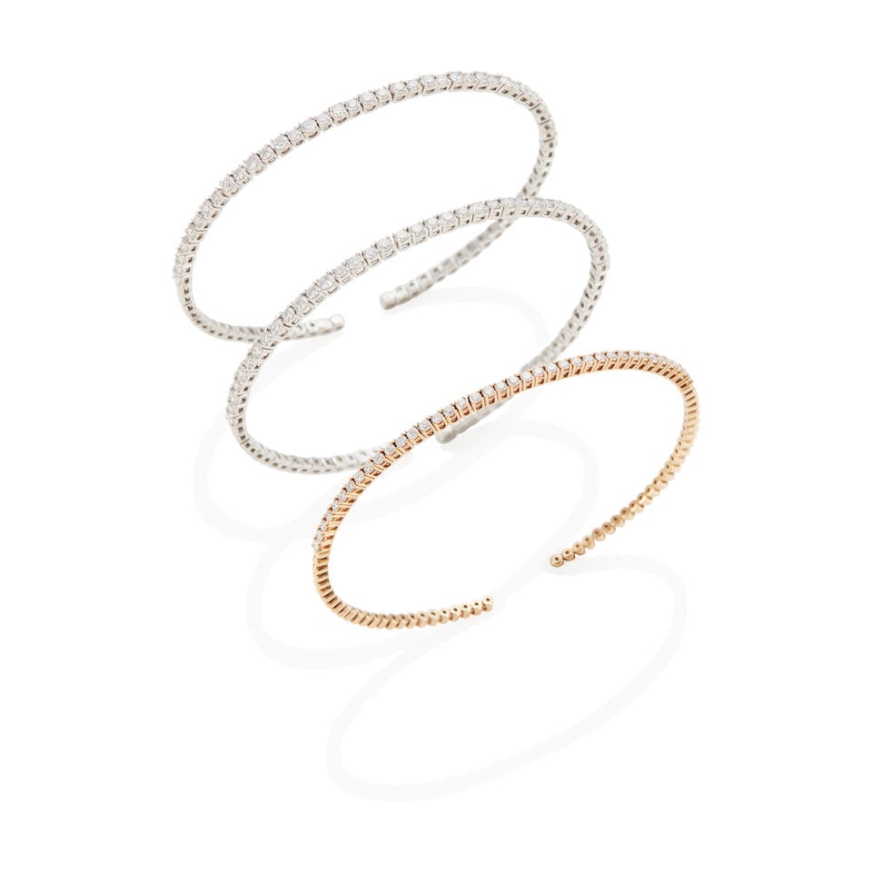 THREE GOLD AND DIAMOND FLEXIBLE CUFF BRACELETS: THREE GOLD AND DIAMOND FLEXIBLE CUFF BRACELETS • One cuff bracelet of 14k white gold with 37 round-cut diamonds weighing approximately 1.40 - 1.50 carats total, stamped with maker's mark, width
