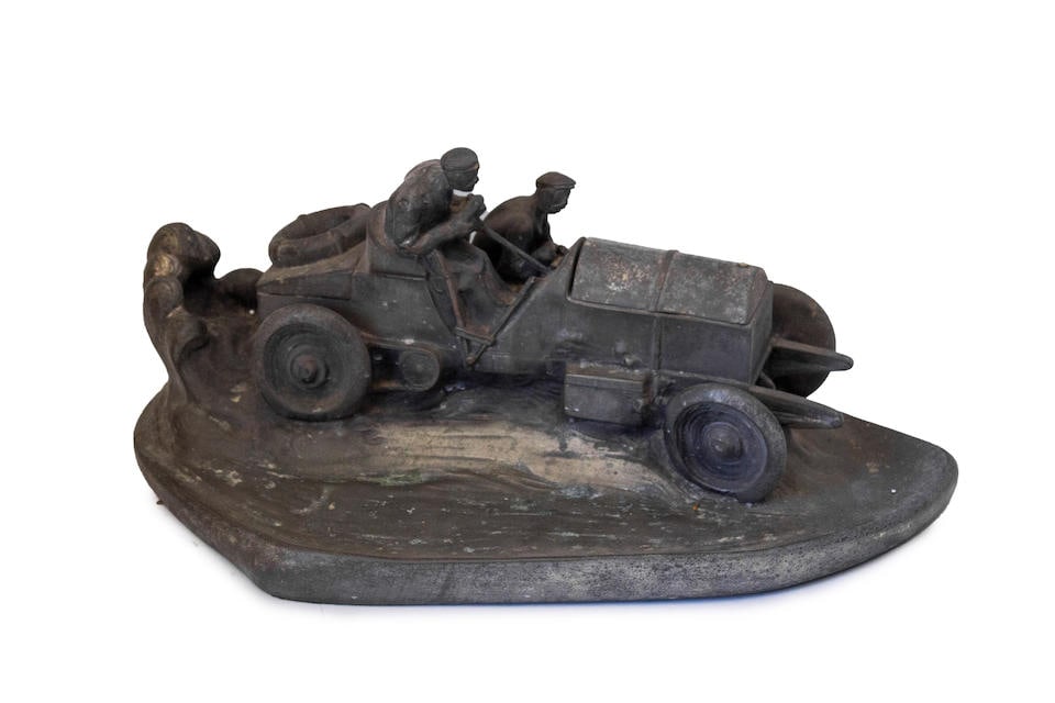 A vintage racecar inkwell desk stand after Wilhelm Zwick,: A vintage racecar inkwell desk stand after Wilhelm Zwick, with hinged bonnet revealing an ink well and dished front for pens, hinges on bonnet are broken, rough exterior from age, 6'H. x 15'L. x 8'W. 