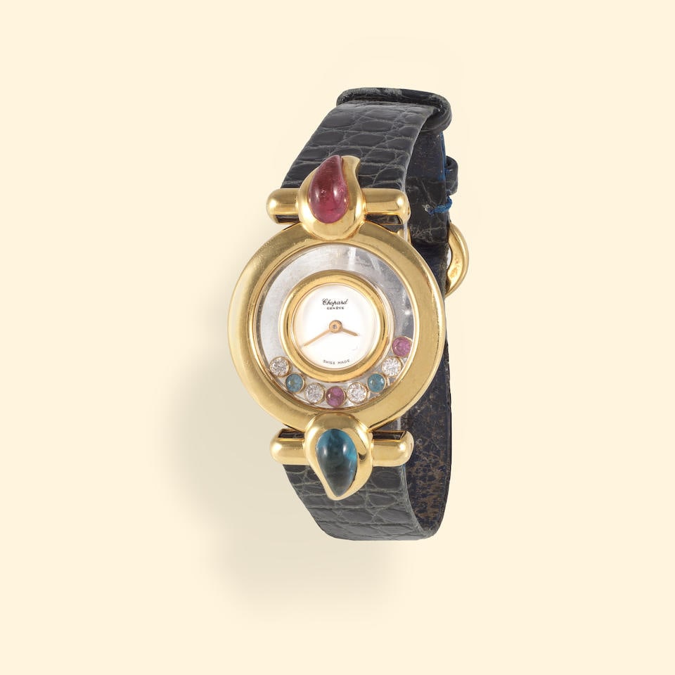 Chopard. A lady's 18K gold quartz wristwatch with topaze and tourmaline set bezel Chopard. Montr... (1 of 1)