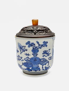 A blue and white 'bogu' incense burner Kangxi period: A blue and white 'bogu' incense burner Kangxi period with a rosewood cover with agate finial, 13.2cm high Footnotes: Provenance: Graham & Elizabeth Cocks, Sydney Bonhams, Sydney, 18 Nov 2012, lot 142