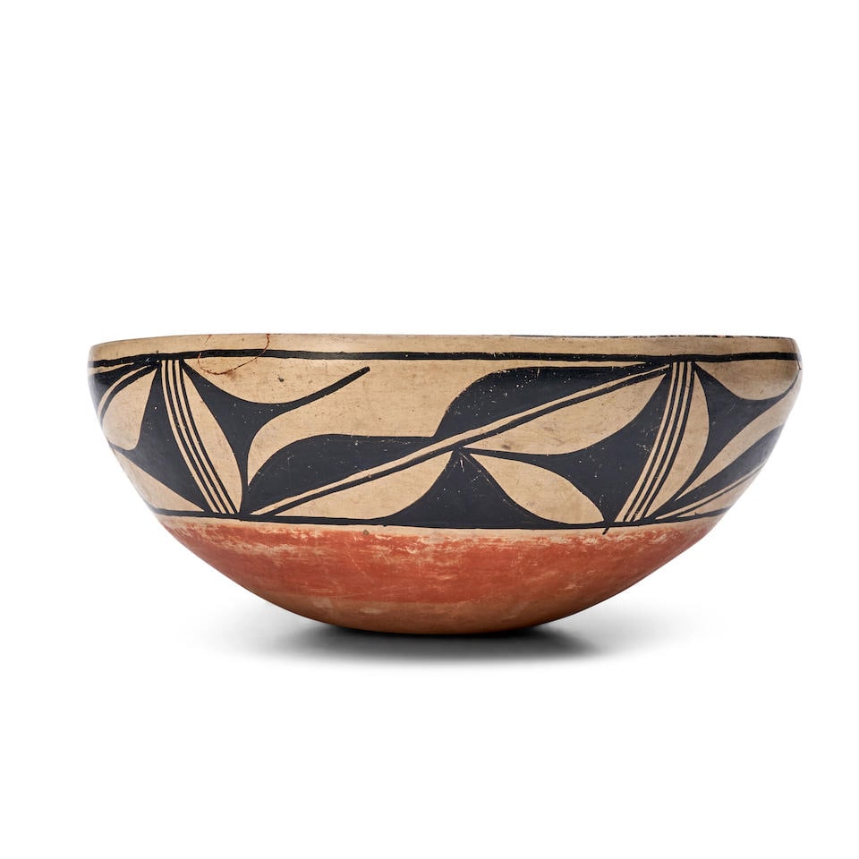 KEWA (SANTO DOMINGO) POLYCHROME DOUGH BOWL ht. 6, wd. 13 in.: KEWA (SANTO DOMINGO) POLYCHROME DOUGH BOWL The redware form painted on the outside with a wide black foliate band in black on a buff ground, (two repairs to chips to rim). ht. 6, wd. 13 in. Footnotes