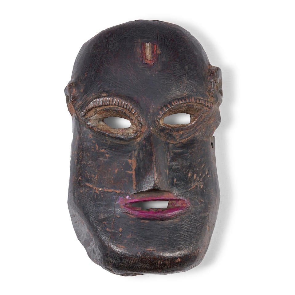 NEPALI TRIBAL MASK ht. 10, wd. 6 in.: NEPALI TRIBAL MASK West Nepal, early 20th century, the hollowed-out hardwood with dark patina and pigments, (wood loss around the rim and cracks). ht. 10, wd. 6 in. Footnotes: OVERALL CONDITION: Showi