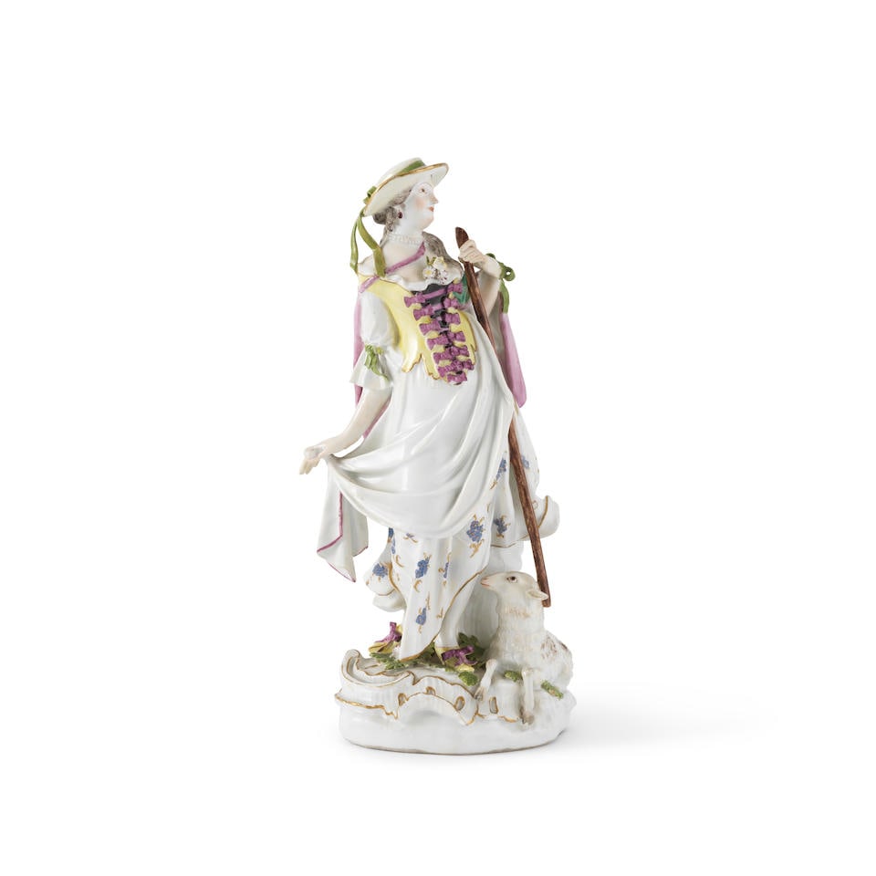 Statuette en porcelaine de Meissen représentant une bergère, circa 1750A Meissen figur...: Statuette en porcelaine de Meissen représentant une bergère, circa 1750 A Meissen figure of a shepherdess, circa 1750 Modelled standing holding her staff, a sheep reclined by her side, her o