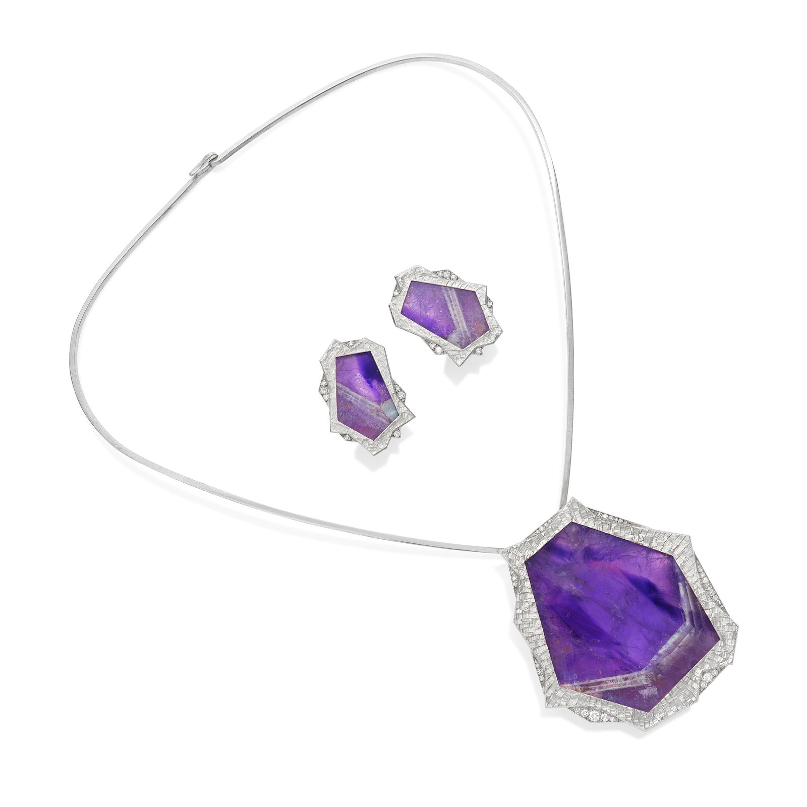 GRIMA: AMETHYST AND DIAMOND 'STICKS AND STONES' BROOCH/PENDANT, TORQUE AND EARCLIP SUITE, 1973 (2): GRIMA: AMETHYST AND DIAMOND 'STICKS AND STONES' BROOCH/PENDANT, TORQUE AND EARCLIP SUITE, 1973 The large amethyst slice within a textured surround of abstract form, accented by brilliant-cut diamonds,