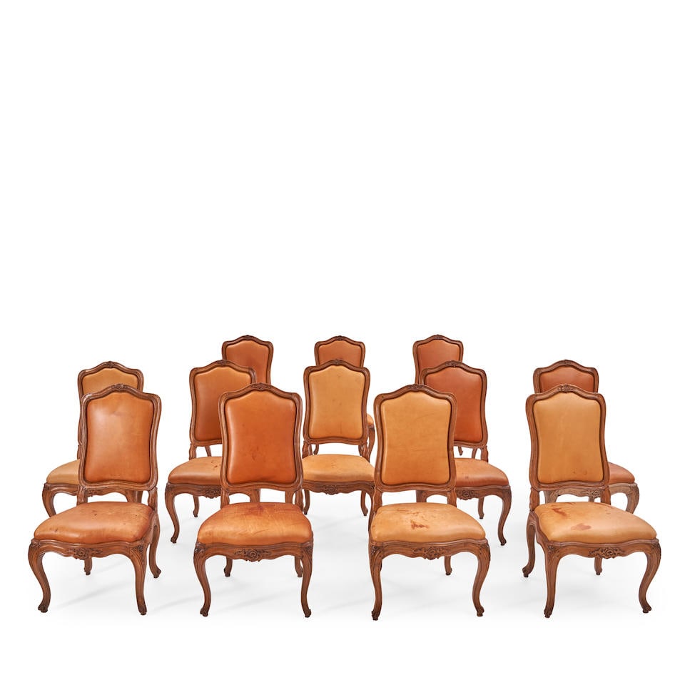 A Set of Twelve Louis XV Provincial Walnut Chaises, Possibly North Italian, Mid 18th Century,: A Set of Twelve Louis XV Provincial Walnut Chaises, Possibly North Italian, Mid 18th Century, the cartouche-form back with channeled frame upholstered in leather, above a shaped seat identically uphol
