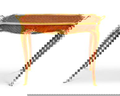 A 20th century gilt bronze mounted red stained wood and fruitwood parquetry tea table In the Bel...: A 20th century gilt bronze mounted red stained wood and fruitwood parquetry tea table In the Belle Epoque style and in the manner of Francois Linke Mounted with foliate chutes, with a shaped lozenge t