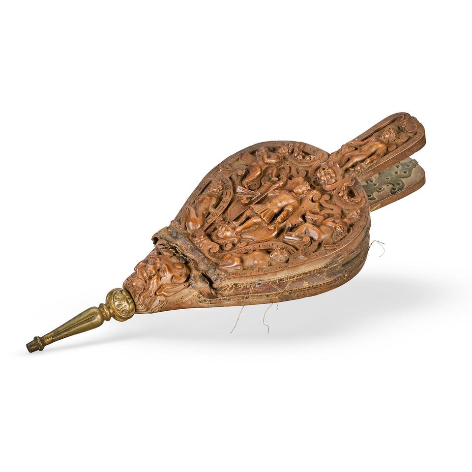 A pair of Continental carved fruitwood bellows Probably second half 16th century: A pair of Continental carved fruitwood bellows Probably second half 16th century One side relief carved with a central figure holding a staff, flanked by putti, and grotesques, the handle with a class