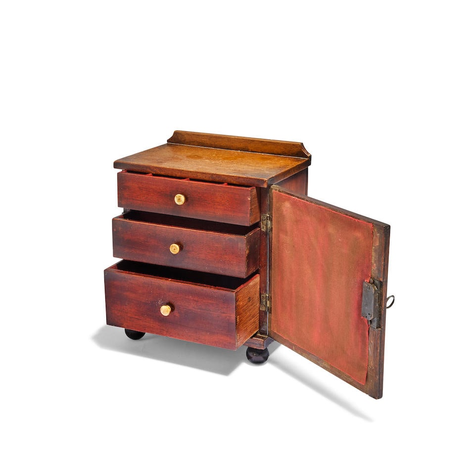 An unusual Regency miniature stained mahogany giltwood miniature chest: An unusual Regency miniature stained mahogany giltwood miniature chest Formed as a pipe organ, fitted three drawers, the whole raised on bun feet, with key, 19.4cm high, 15.8cm wide, 10.6cm deep For f