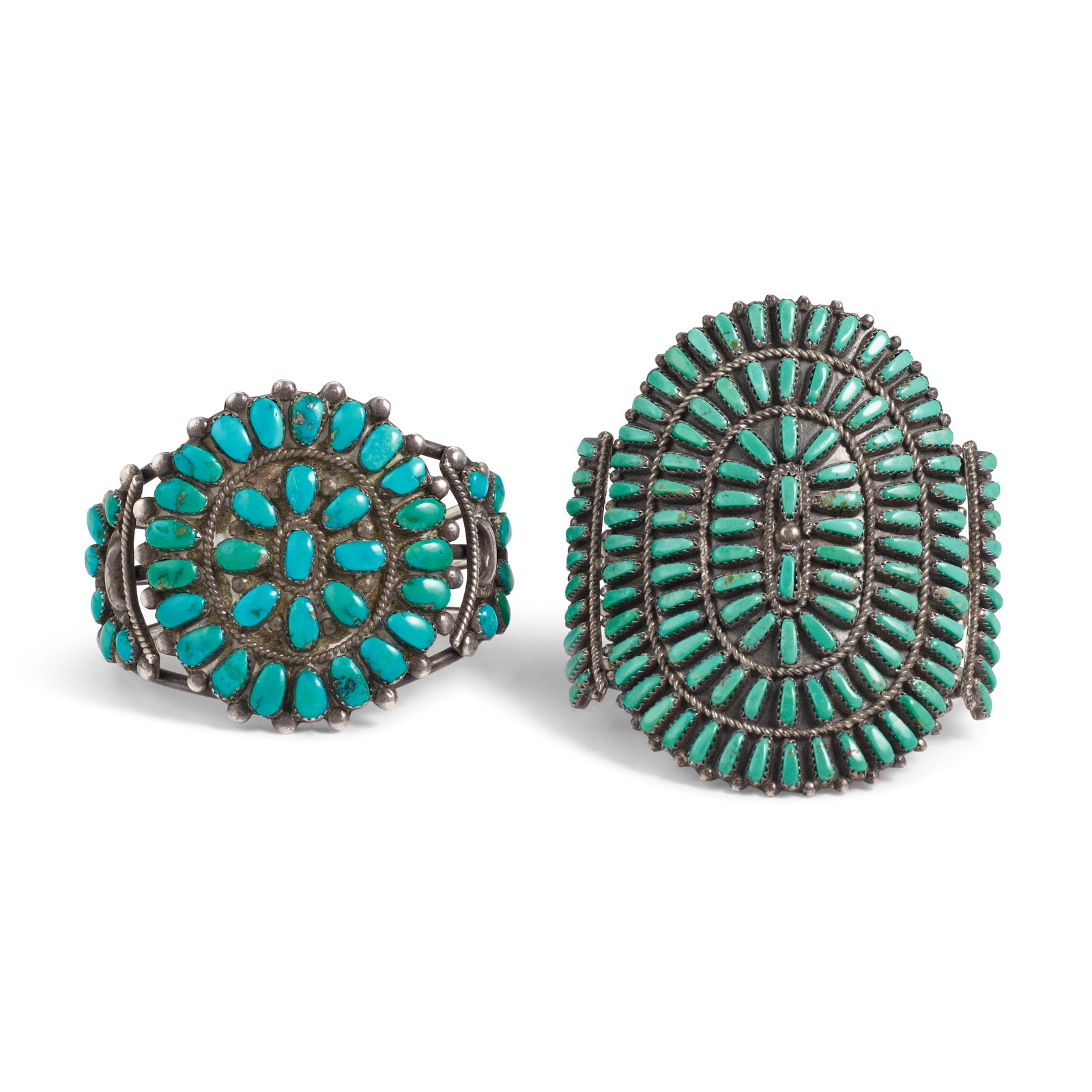 Two Zuni cuff bracelets: Two Zuni cuff bracelets Each constructed of silver wire supporting rounded plaques set with clusters of turquoise with twisted wire accents; each unsigned, the larger stamped: Sterling. smaller: inner