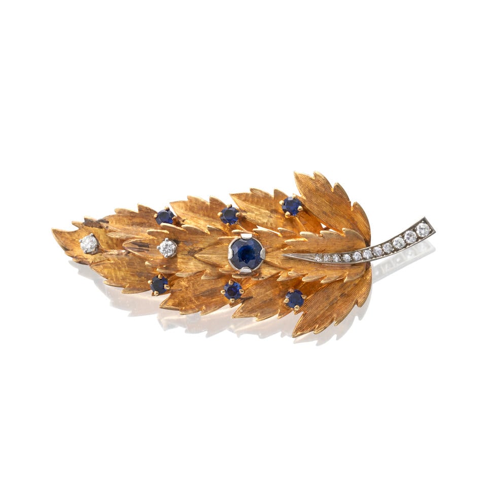 ERWIN PEARL: AN 18K GOLD, SAPPHIRE, AND DIAMOND LEAF BROOCH: ERWIN PEARL: AN 18K GOLD, SAPPHIRE, AND DIAMOND LEAF BROOCH Designed as a leaf set with circular-cut sapphires and full and single-cut diamonds, weight 15.6 dwt, maker's mark for Erwin Pearl, length