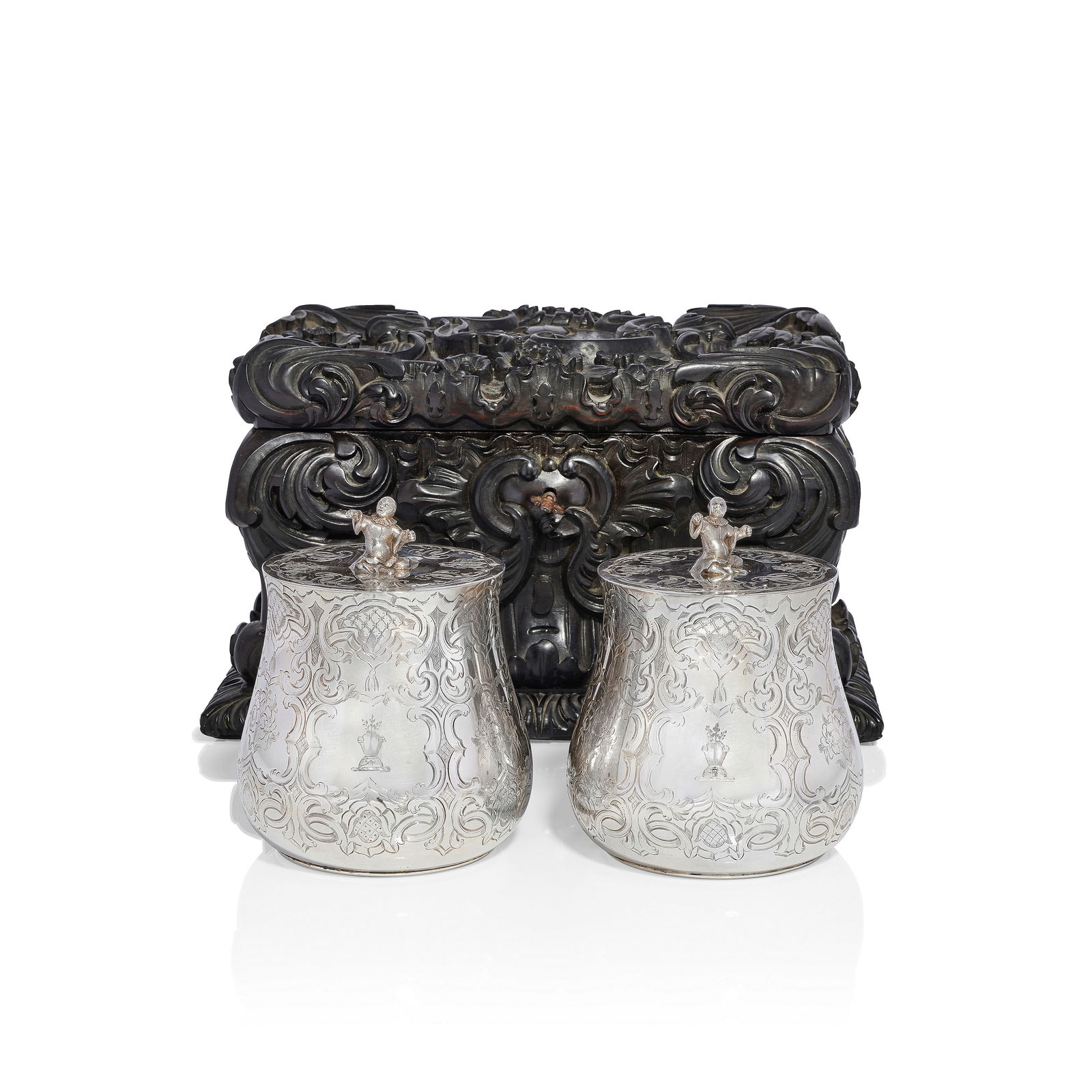 A cased pair of Victorian silver tea caddies in carved ebony box Charles Thomas Fox & George F...: A cased pair of Victorian silver tea caddies in carved ebony box Charles Thomas Fox & George Fox, London 1845, the case possibly Anglo-Indian, Galle district, Ceylon Cylindrical low bellied form with