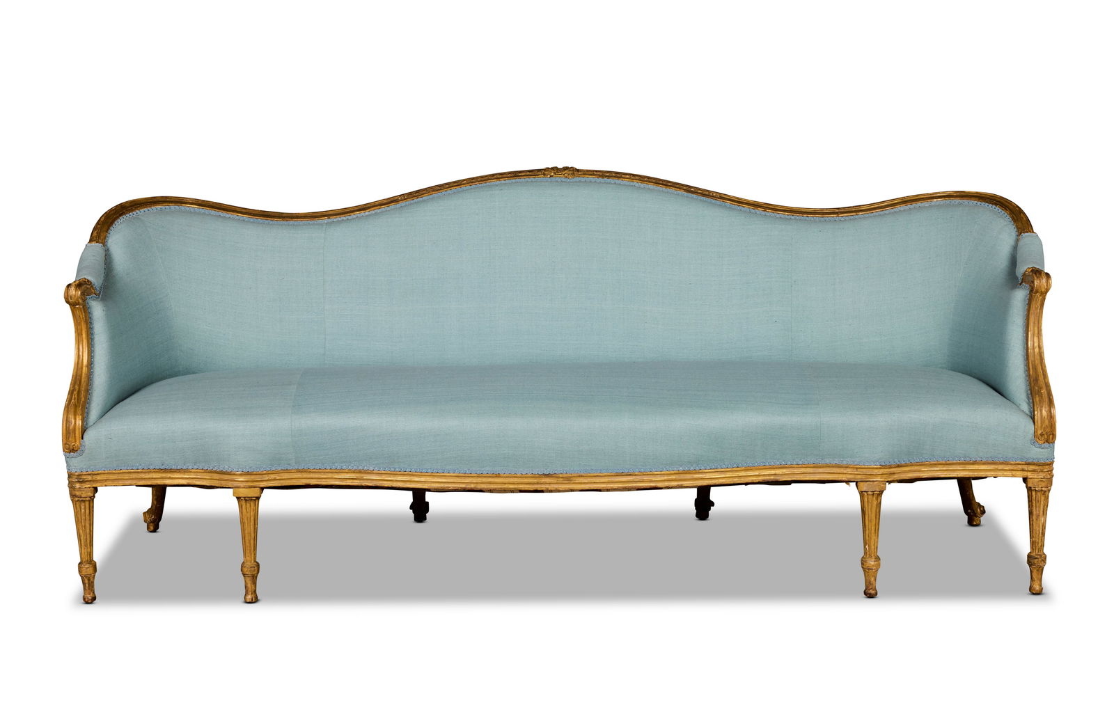 A George III giltwood sofa Almost certainly made within the circle of Thomas Chippendale in the ...: A George III giltwood sofa Almost certainly made within the circle of Thomas Chippendale in the period: 1775-1780 With channelled frames, the shaped arched back carved with a ribbon tied husk pendant