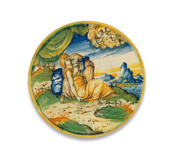 A Venice maiolica istoriato dish, workshop of Domenico da Venezia, circa 1560-80: A Venice maiolica istoriato dish, workshop of Domenico da Venezia, circa 1560-80Painted with a landscape scene depicting two women embracing, below drapery at the top and Cupid emerging from clouds
