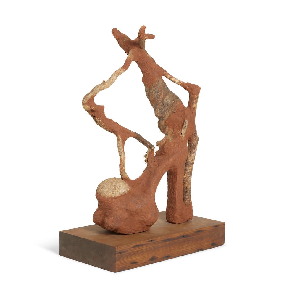 WANGECHI MUTU (B. 1972) Heeler XVI 17 x 4 ½ x 10 in (43.2 x 11.4 x 25.4 cm) (Executed in 20...: WANGECHI MUTU (B. 1972) Heeler XVI red soil, acrylic shoe, paper pulp, wood glue, rocks and wood 17 x 4 ½ x 10 in (43.2 x 11.4 x 25.4 cm) Executed in 2016. This work is unique Footnotes: Provenan