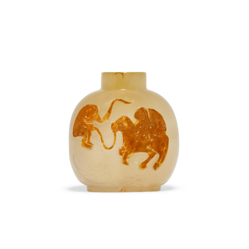 A CARVED AGATE 'HORSE AND MONKEYS' SNUFF BOTTLE 19th century (2): A CARVED AGATE 'HORSE AND MONKEYS' SNUFF BOTTLE 19th century Rising from a short foot to an ovoid body and a cylindrical neck, carved in relief with a jovial monkey riding on a horse led by another mo