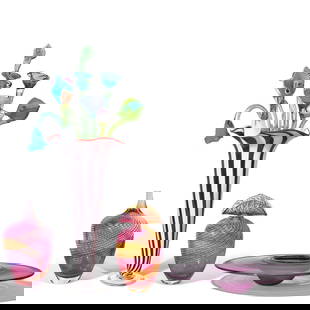 A GROUP OF ART GLASS DECORATIONSLate 20th/21st century: A GROUP OF ART GLASS DECORATIONS Late 20th/21st century Comprising a Benjamin Moore purple centerpiece, a Ken & Ingrid Hanson striped vase, two Buzz Blodgett vases, and eleven long stemmed flowers. (1