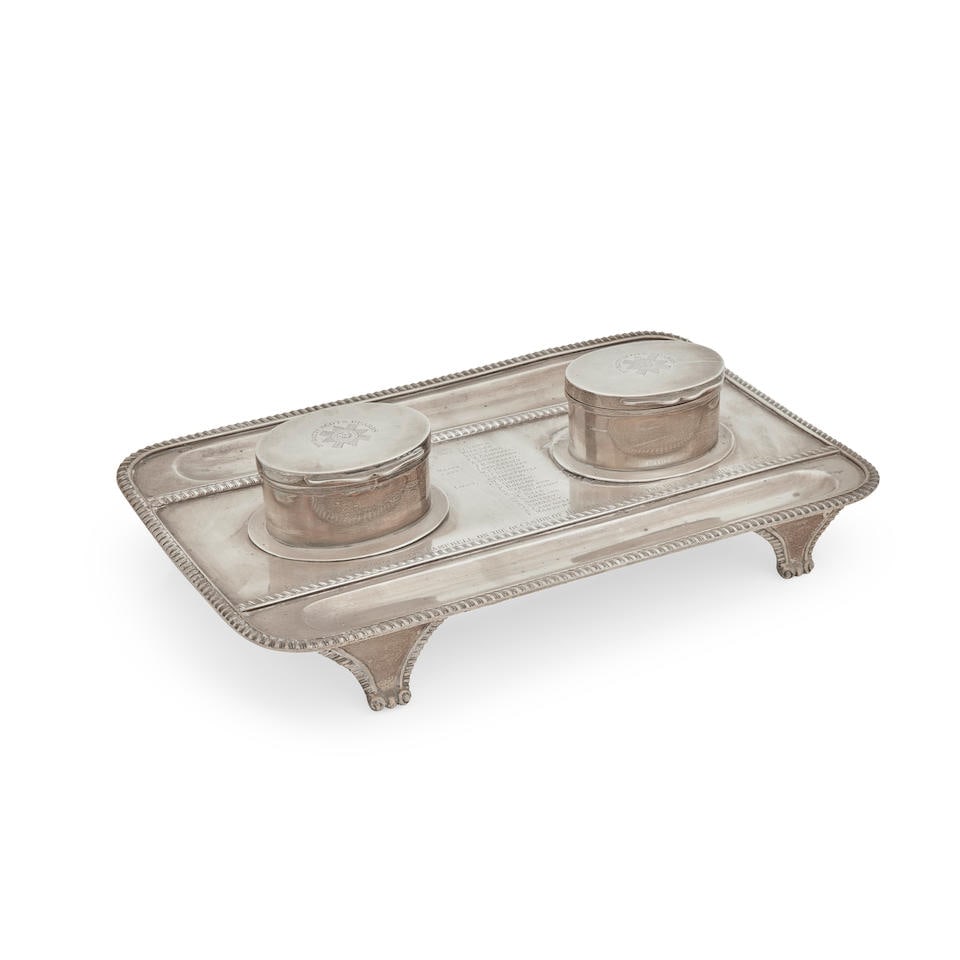 A Victorian presentation silver ink stand By Charles Stuart Harris, London, 1893: A Victorian presentation silver ink stand By Charles Stuart Harris, London, 1893 On four bracket feet and of rounded rectangular form, with gadrooned border, two lidded oval ink bottles, both engrave