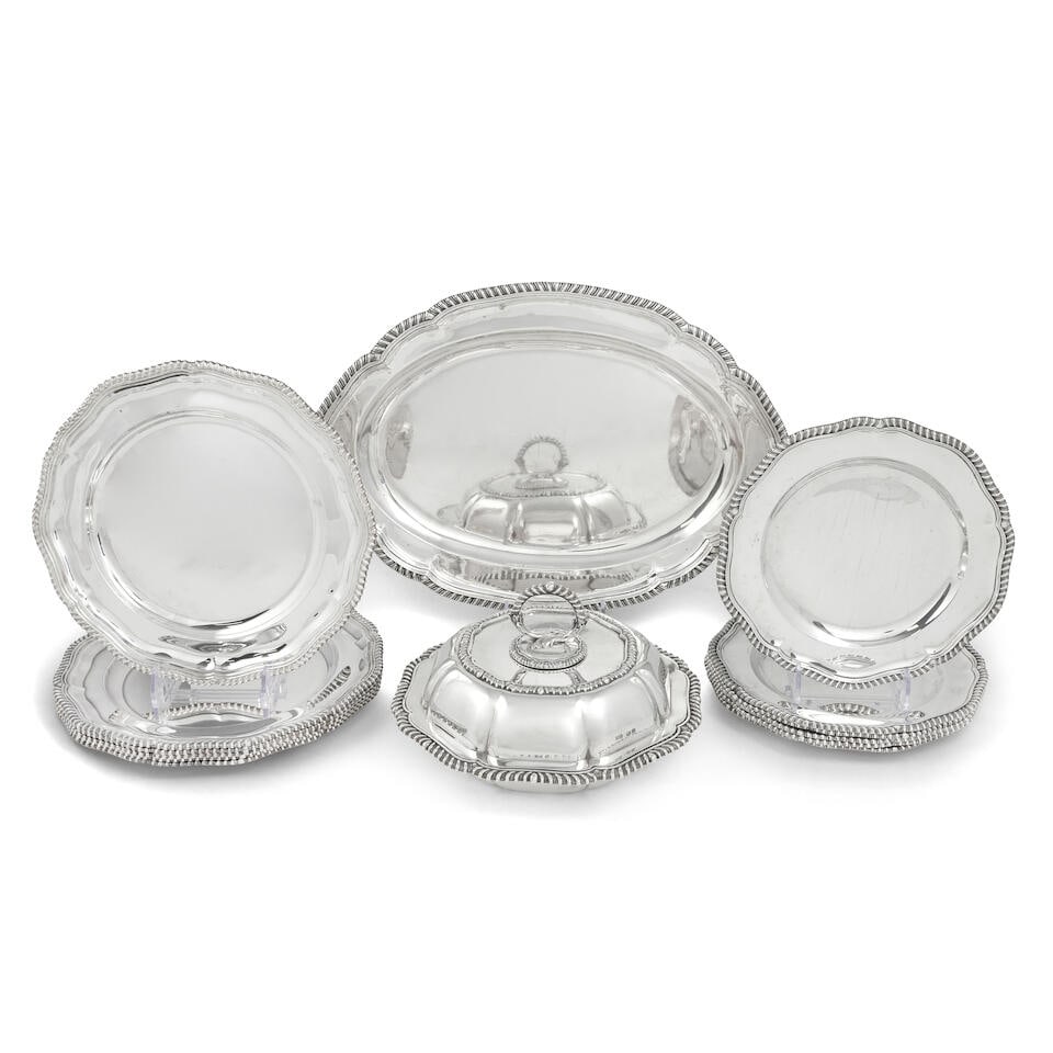 A silver dinner service (14): A silver dinner service Shaped-circular with gadroon borders, comprising: six dinner plates, (four Garrard & Co Ltd, Sheffield 1972, two Richard Woodman Burbridge, Sheffield 1969), six smaller plates