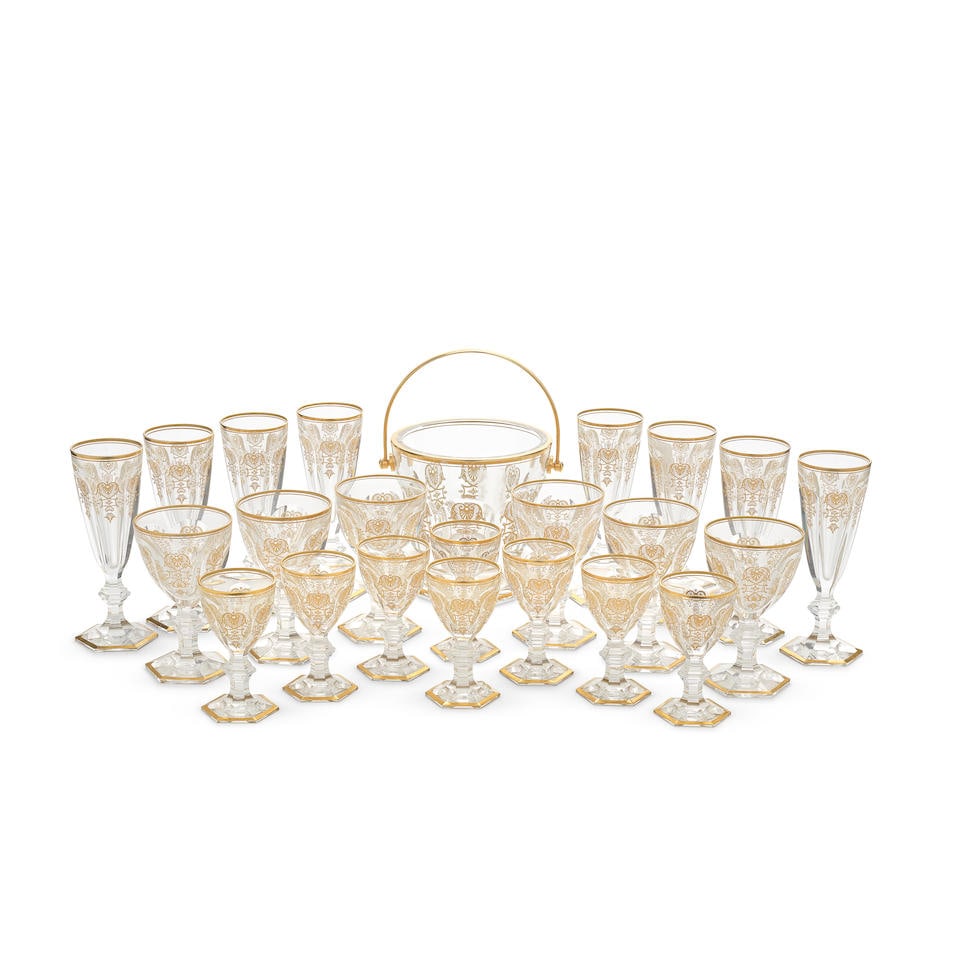 A Baccarat cut and moulded glass Harcourt Empire pattern part suite of glassware (23): A Baccarat cut and moulded glass Harcourt Empire pattern part suite of glassware All with canted arched cut and foliate gilt panelled decoration, the rims and knopped hexagonal pedestal bases with gil